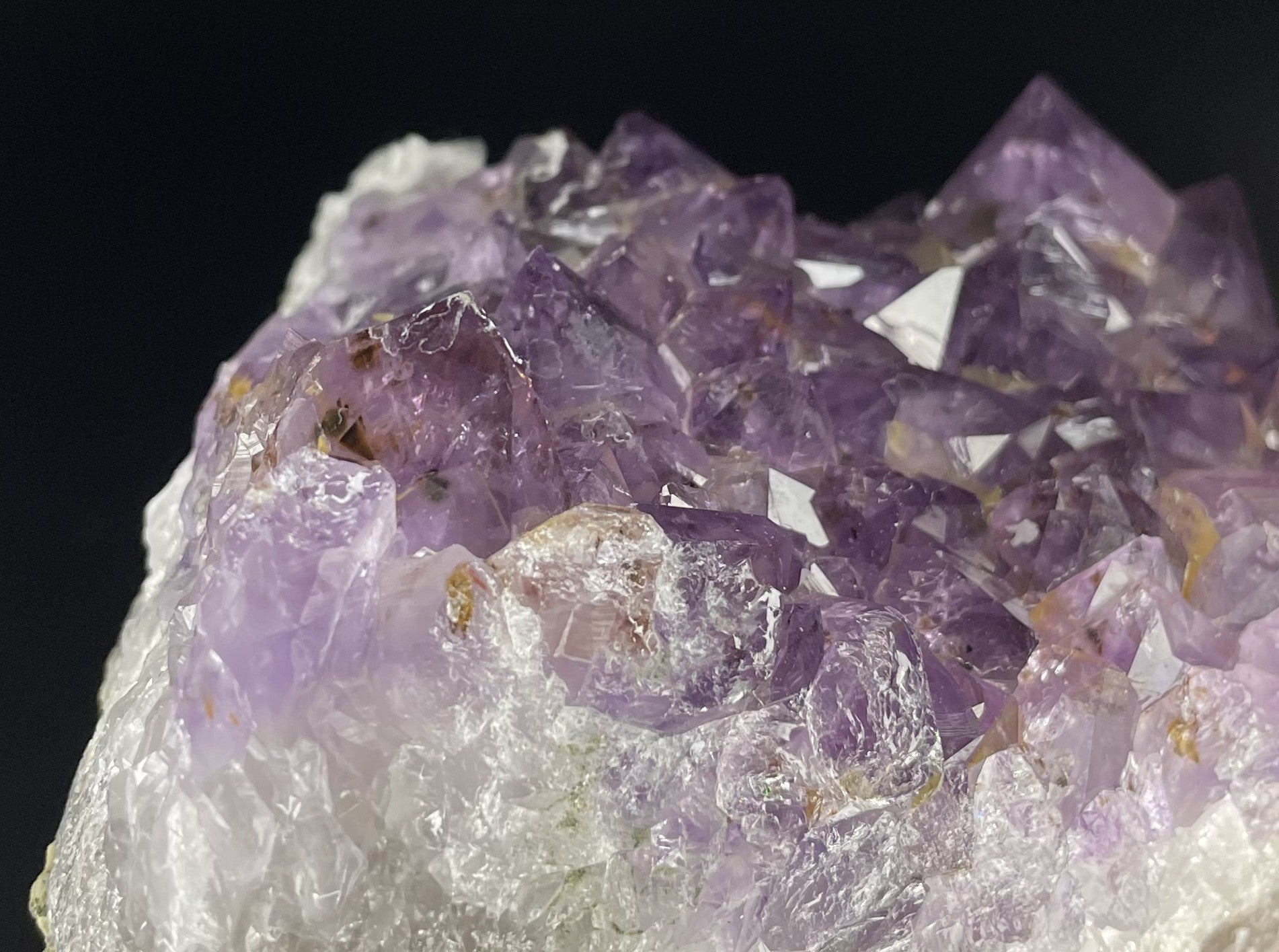 Amethyst cluster with brilliant hues of purple and various sizes of crystal formations