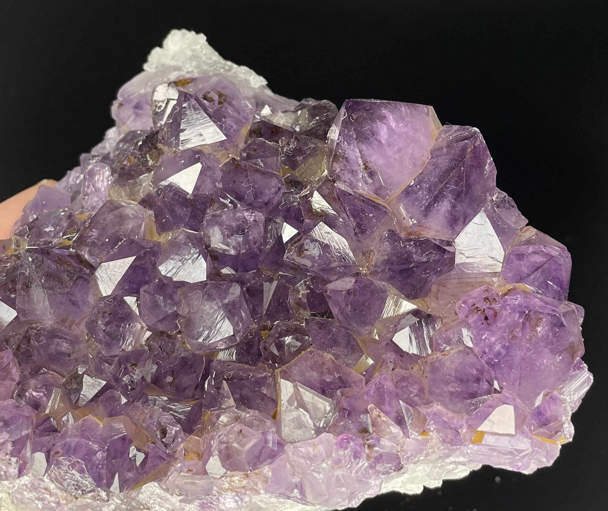 Amethyst cluster with brilliant hues of purple and various sizes of crystal formations