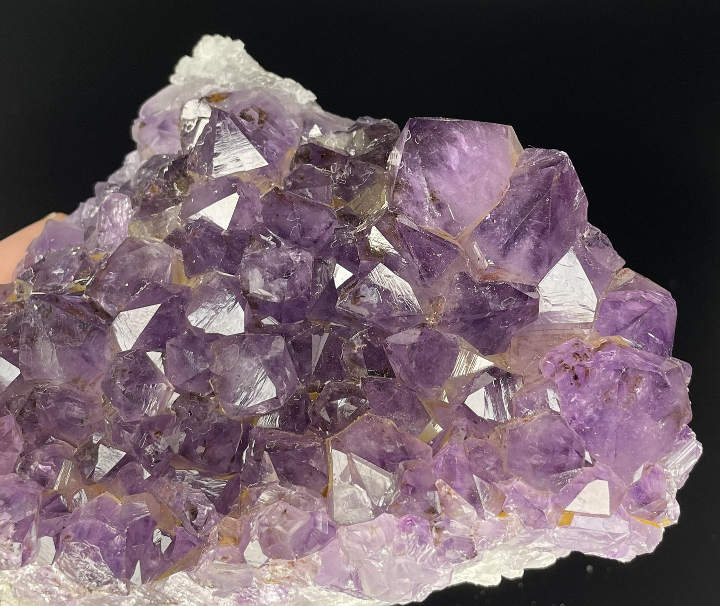 Amethyst cluster with brilliant hues of purple and various sizes of crystal formations.