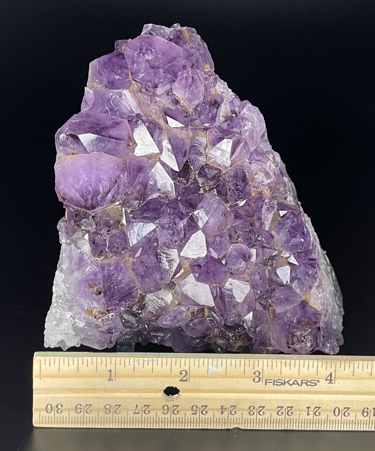 Amethyst cluster with brilliant hues of purple and various sizes of crystal formations