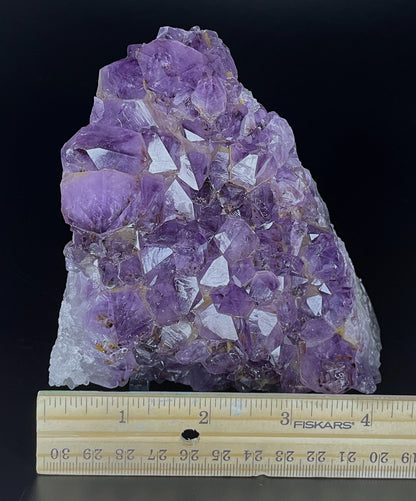 Amethyst cluster with brilliant hues of purple and various sizes of crystal formations.