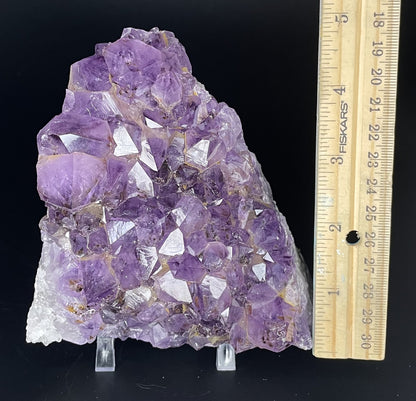 Amethyst cluster with brilliant hues of purple and various sizes of crystal formations