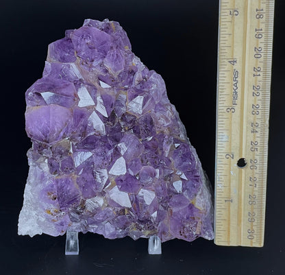 Amethyst cluster with brilliant hues of purple and various sizes of crystal formations.