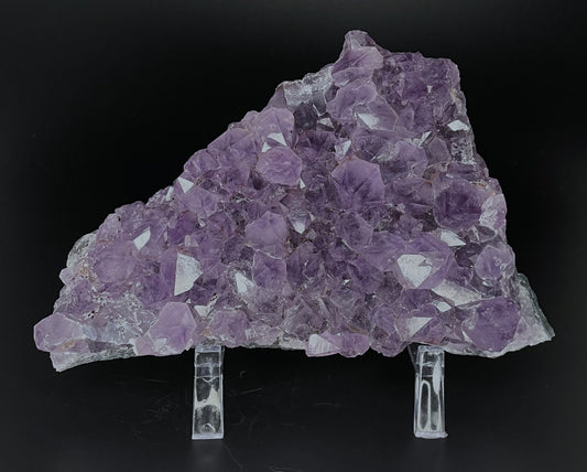 Amethyst cluster with brilliant hues of purple and various sizes of crystal formations.