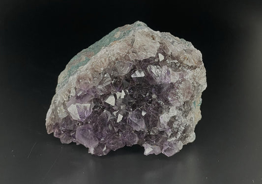 Amethyst cluster with brilliant hues of purple and various sizes of crystal formations