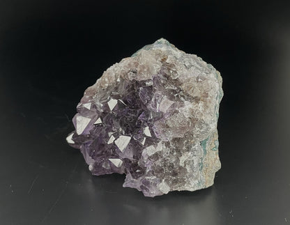 Amethyst cluster with brilliant hues of purple and various sizes of crystal formations