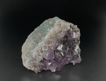 Amethyst cluster with brilliant hues of purple and various sizes of crystal formations