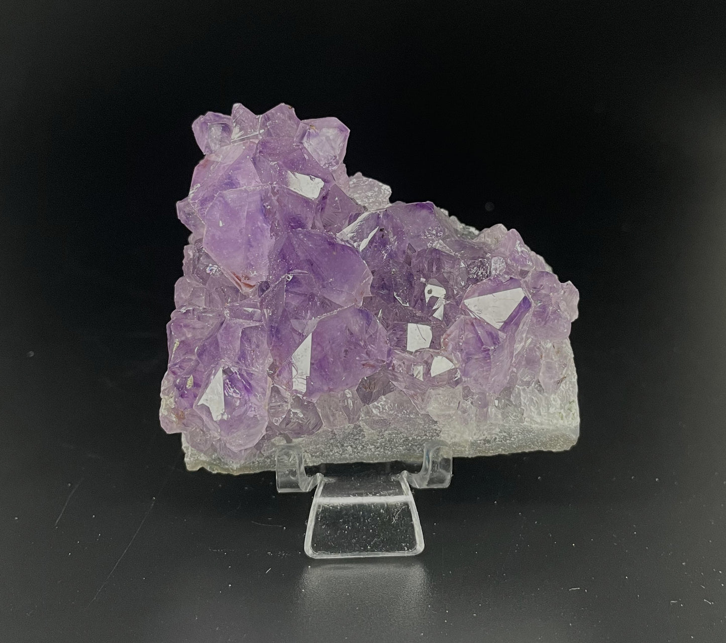 Amethyst cluster with brilliant hues of purple and various sizes of crystal formations