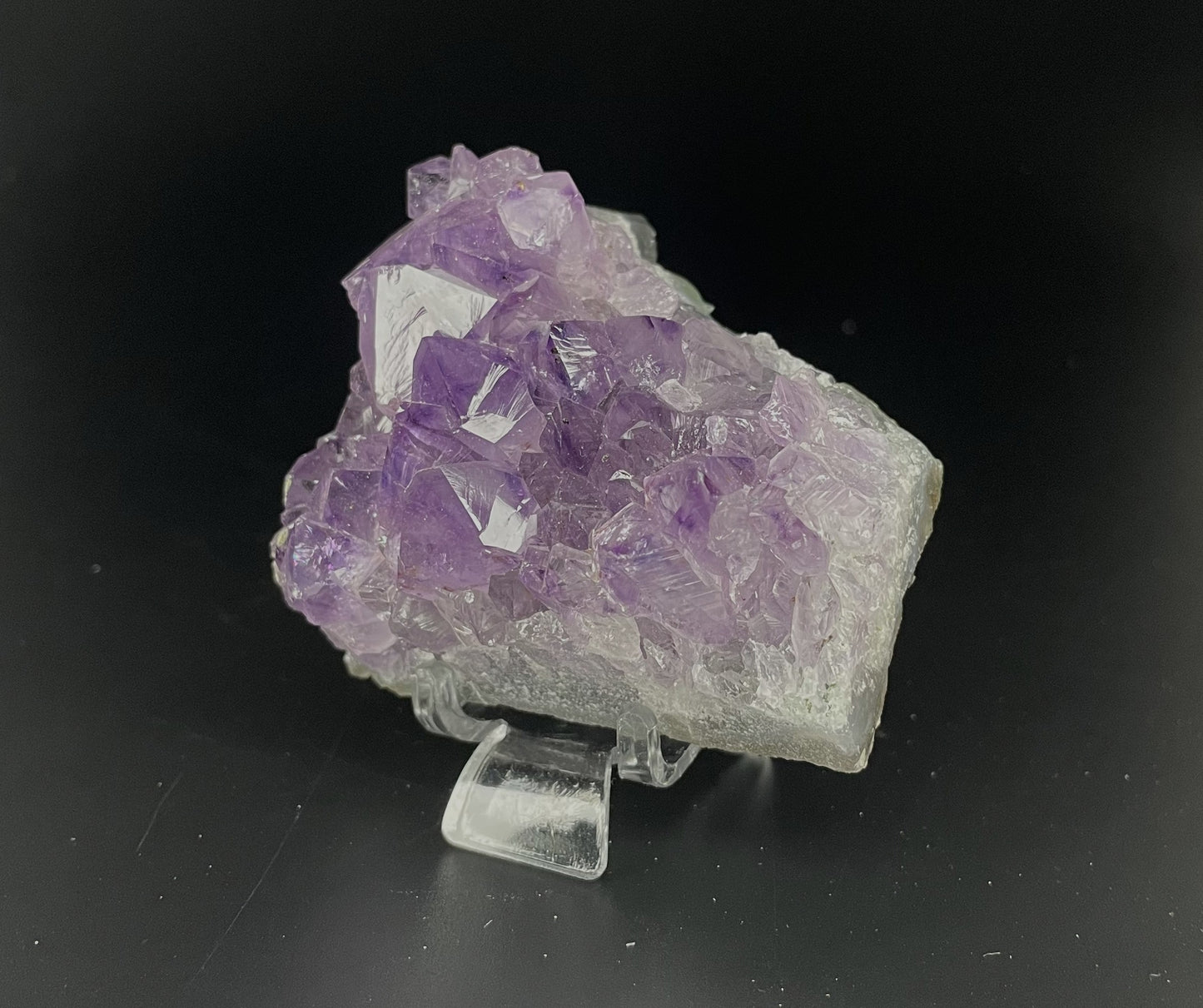 Amethyst cluster with brilliant hues of purple and various sizes of crystal formations