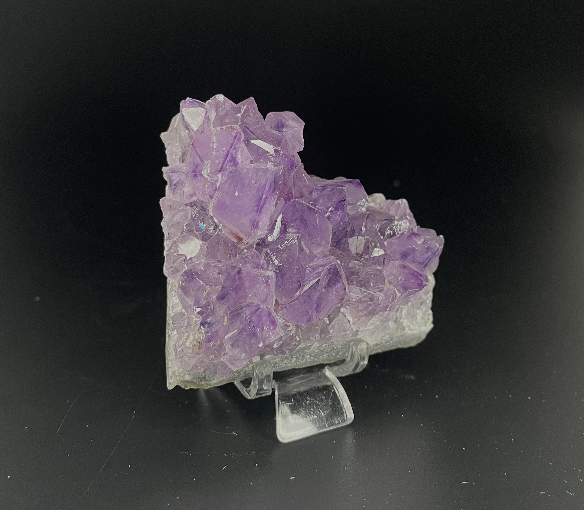 Amethyst cluster with brilliant hues of purple and various sizes of crystal formations