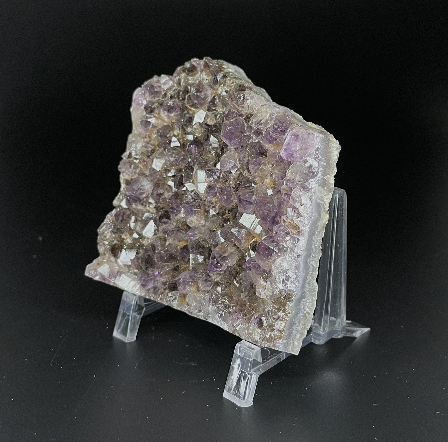 Amethyst cluster with brilliant hues of purple and various sizes of crystal formations