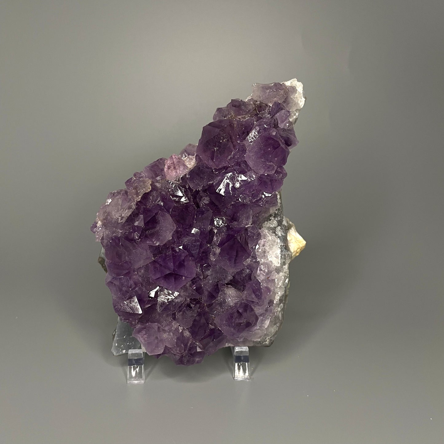 Amethyst cluster with brilliant hues of purple and various sizes of crystal formations.