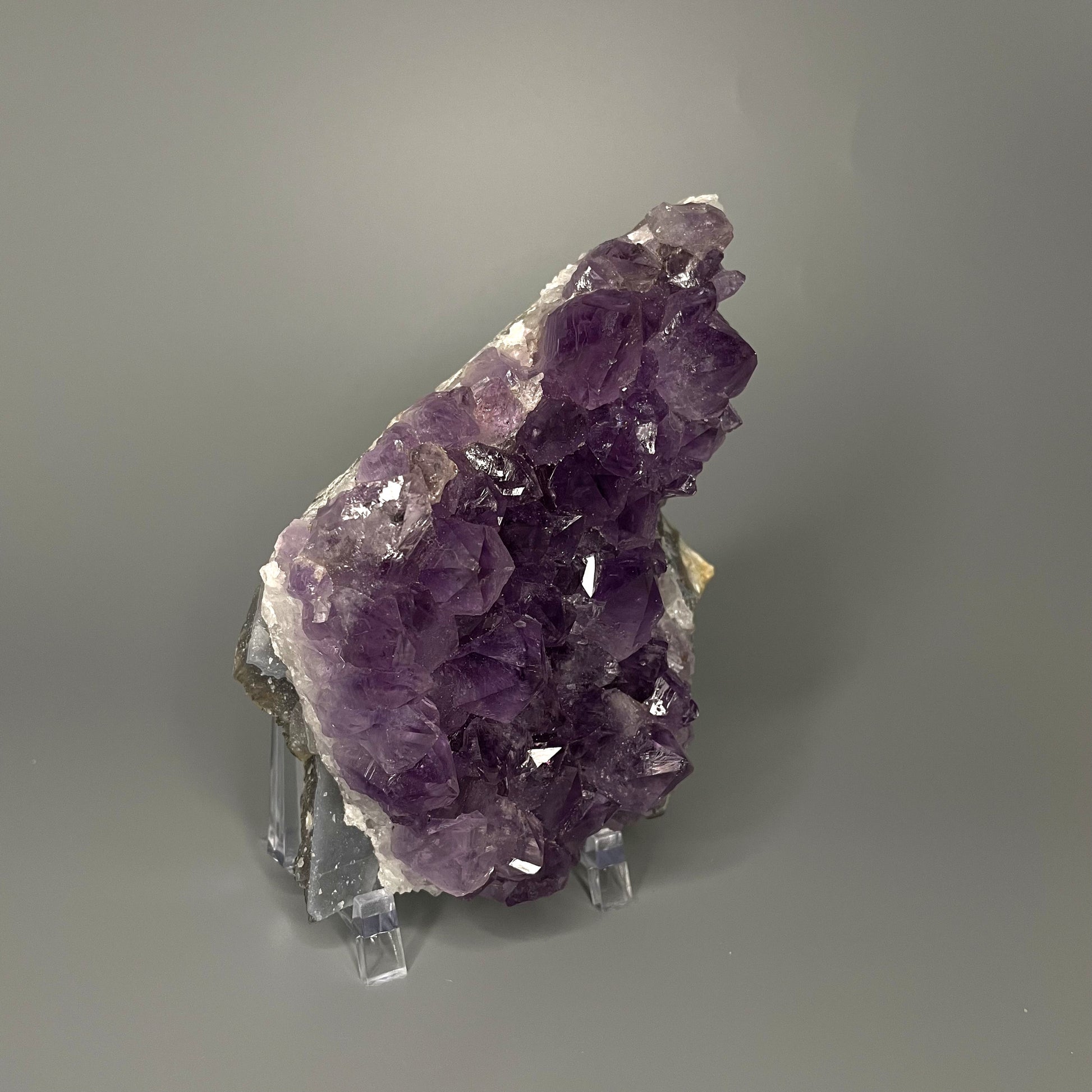 Amethyst cluster with brilliant hues of purple and various sizes of crystal formations.