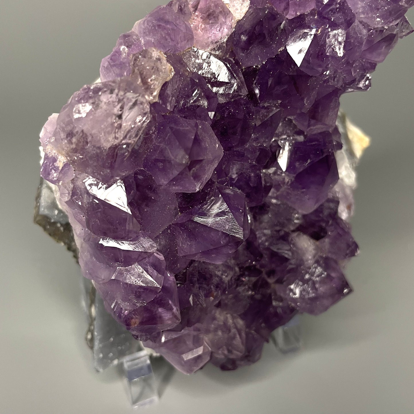 Amethyst cluster with brilliant hues of purple and various sizes of crystal formations.