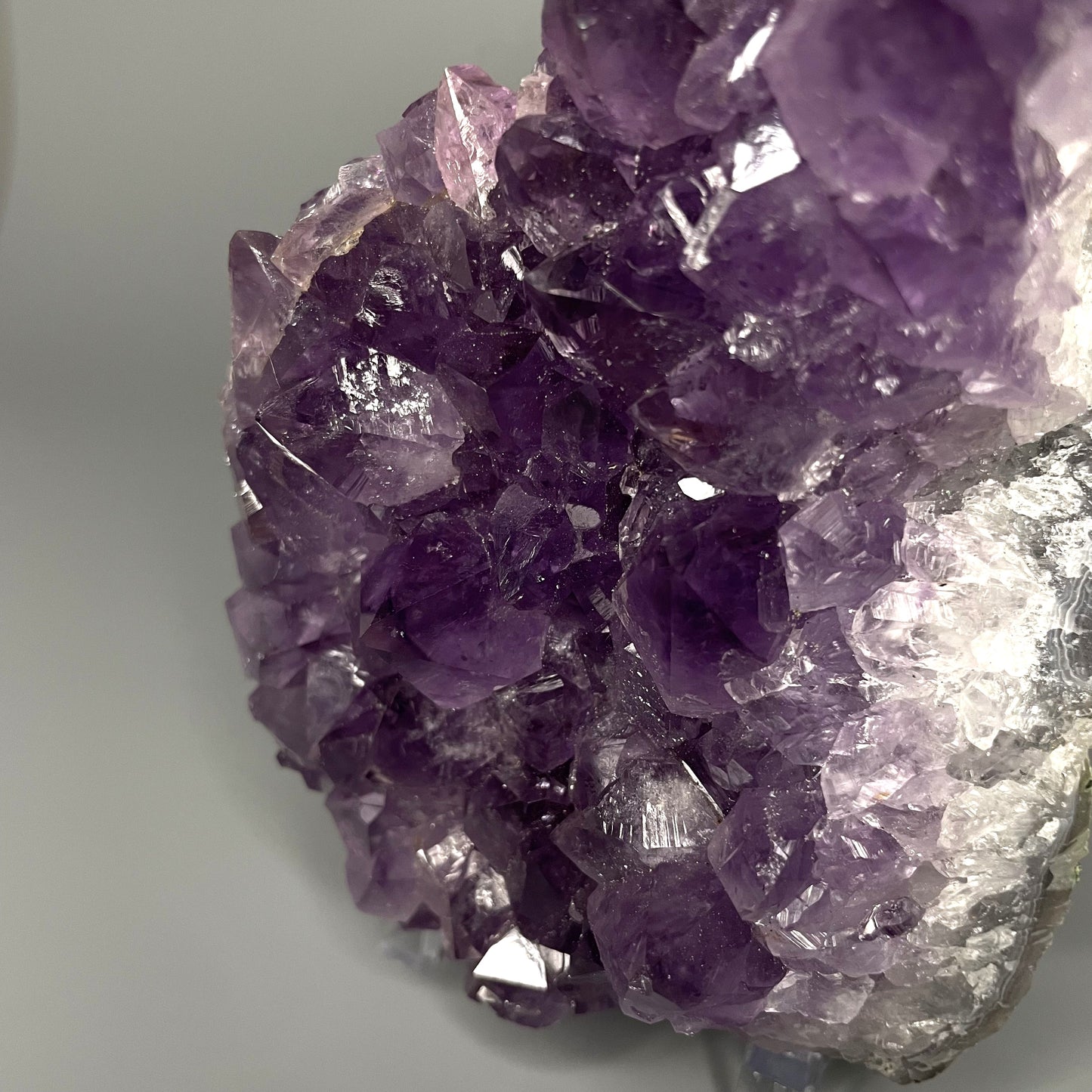 Amethyst cluster with brilliant hues of purple and various sizes of crystal formations.