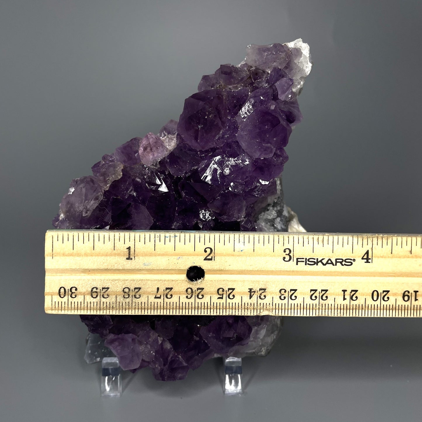 Amethyst cluster with brilliant hues of purple and various sizes of crystal formations.