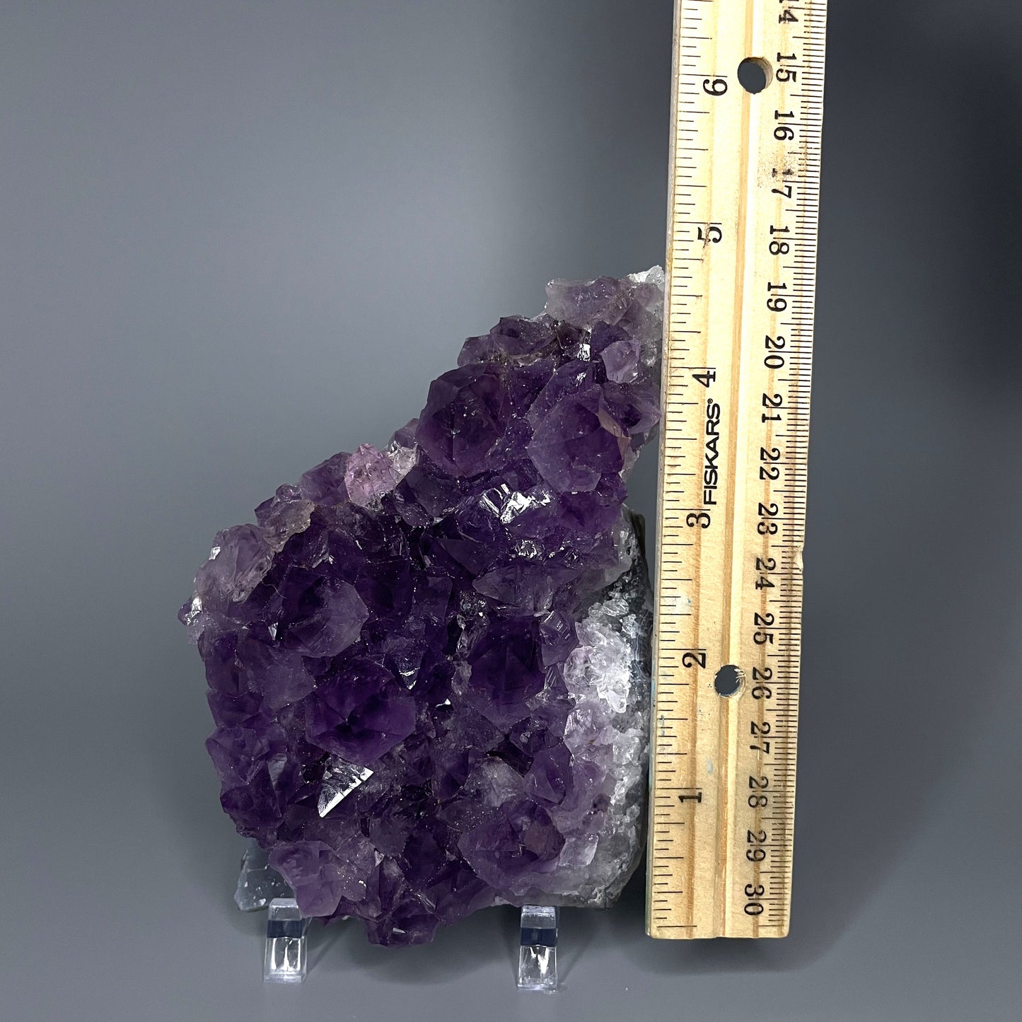 Amethyst cluster with brilliant hues of purple and various sizes of crystal formations.