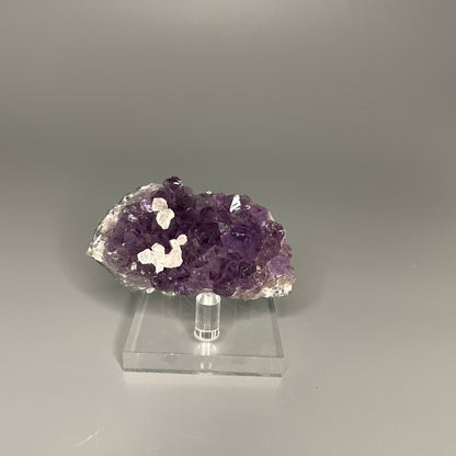 Amethyst cluster with brilliant hues of purple and various sizes of crystal formations.