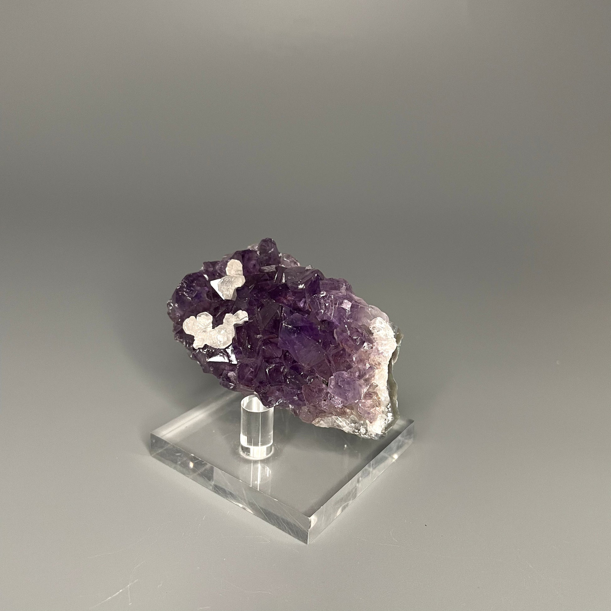 Amethyst cluster with brilliant hues of purple and various sizes of crystal formations.