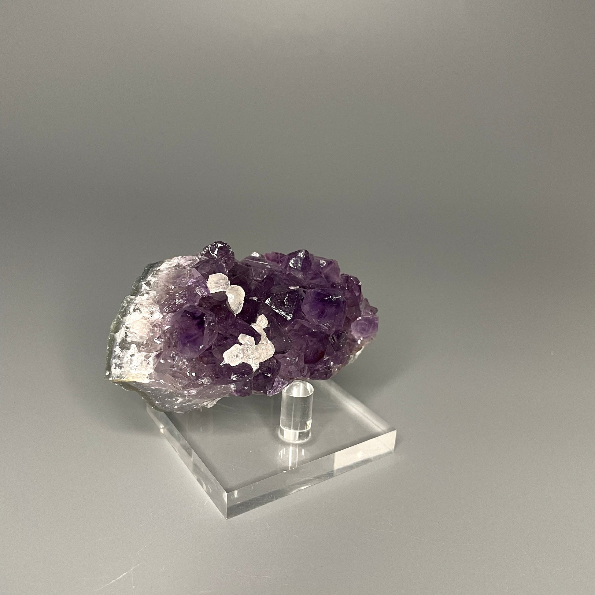 Amethyst cluster with brilliant hues of purple and various sizes of crystal formations.