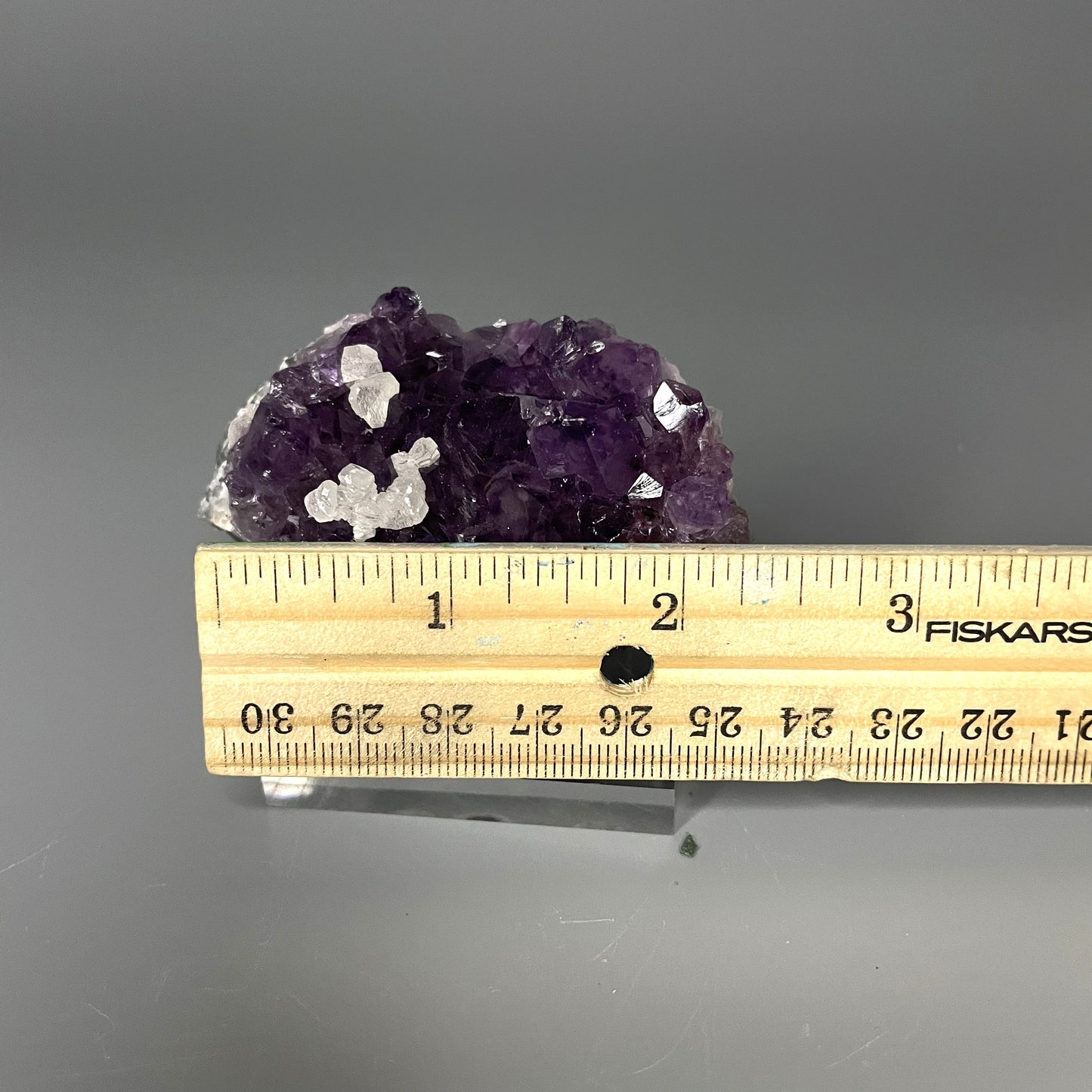 Amethyst cluster with brilliant hues of purple and various sizes of crystal formations.