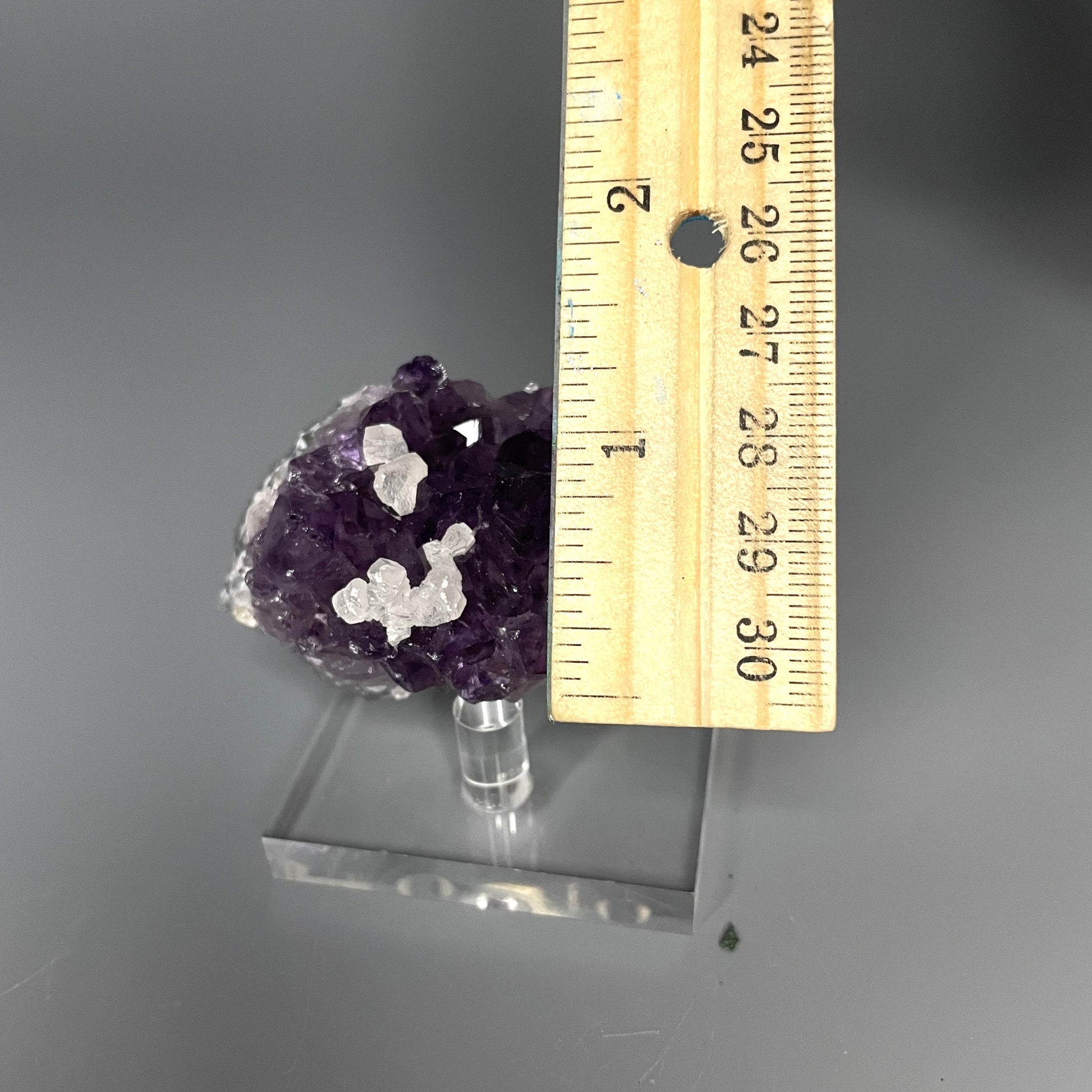 Amethyst cluster with brilliant hues of purple and various sizes of crystal formations.