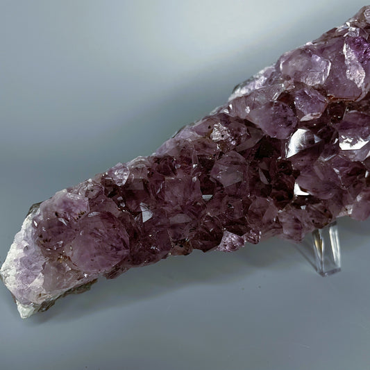 Amethyst cluster with brilliant hues of purple and various sizes of crystal formations.