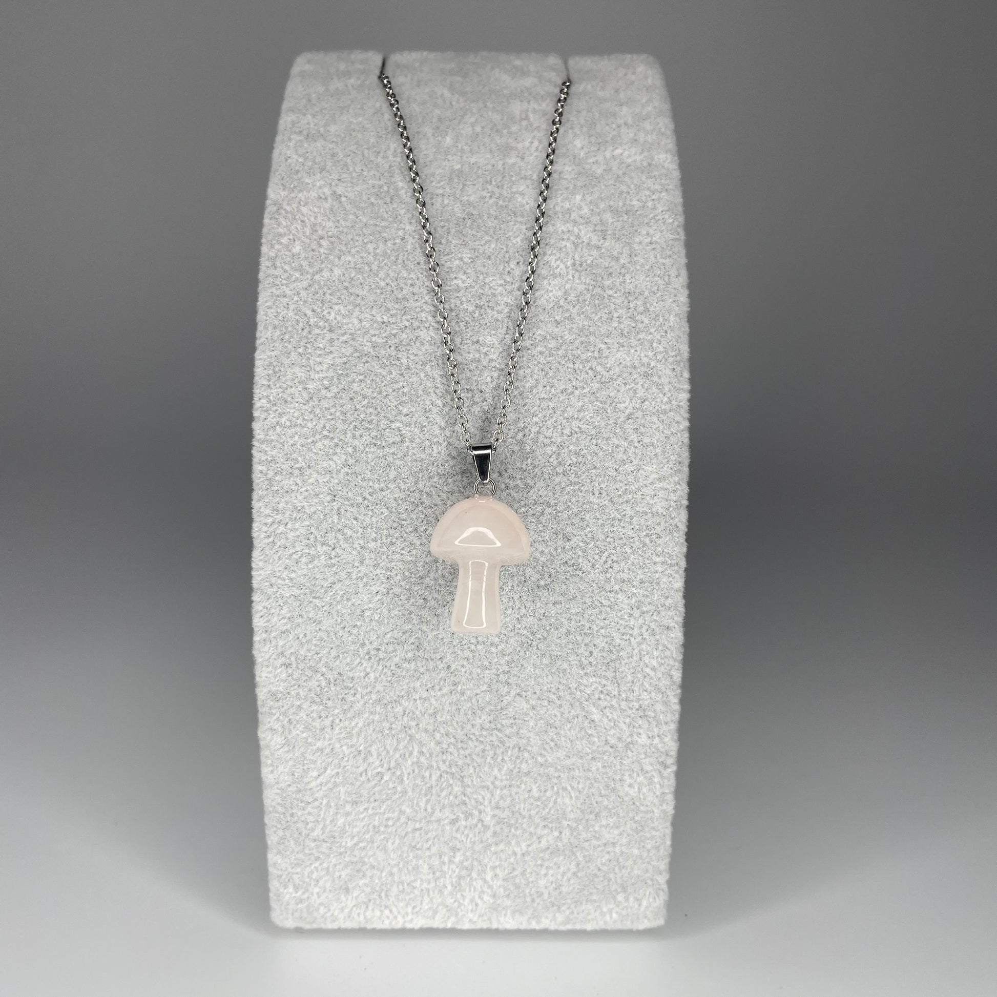 A 3 cm mushroom-shaped pendant carved from various minerals with a stainless steel chain or black nylon necklace.