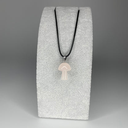 A 3 cm mushroom-shaped pendant carved from various minerals with a black nylon necklace.