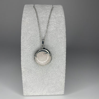 A 3 cm cabochon pendant featuring a dolphin design on a polished stone, available in various minerals, with a stainless steel chain.