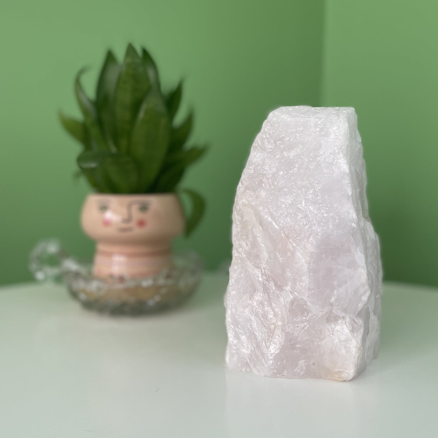 A glowing Rose Quartz Mineral Lamp with soft pink hues.