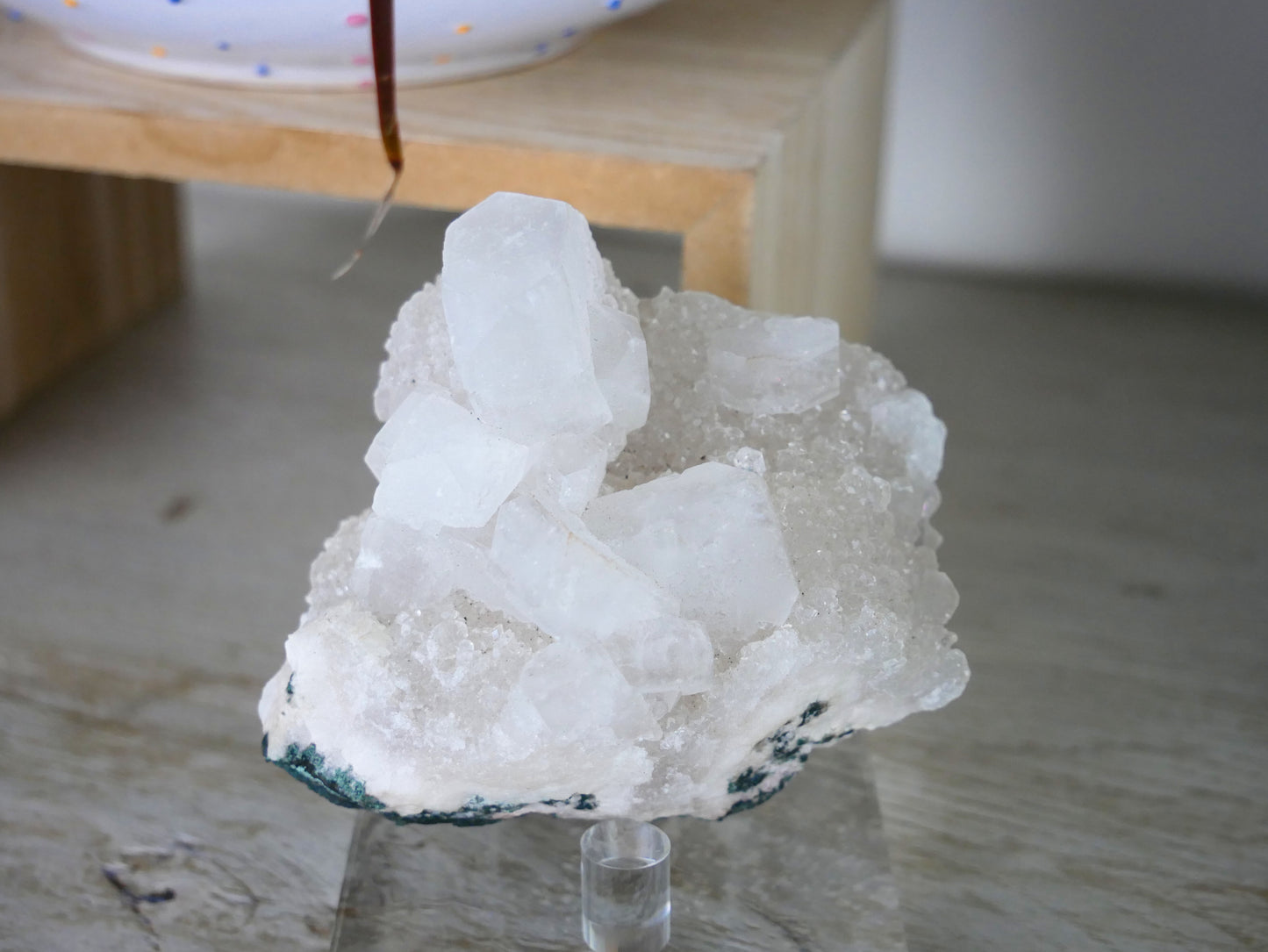 Close-up image of 9.3 oz Apophyllite crystal specimen, showcasing its natural pyramid-shaped structure and translucent, sparkly surface.