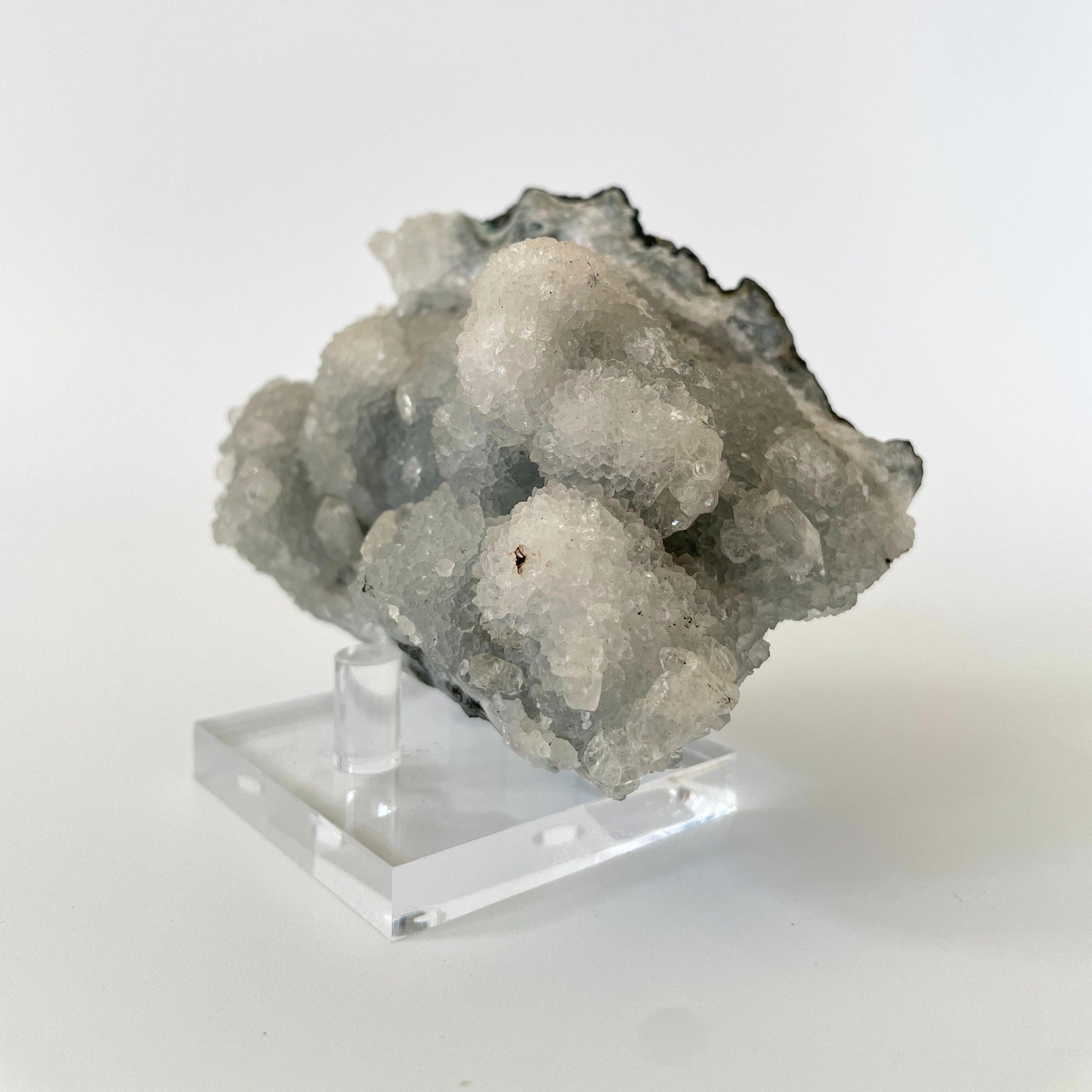 A 4-inch rare blue chalcedony cluster with soft blue hues on a white background.