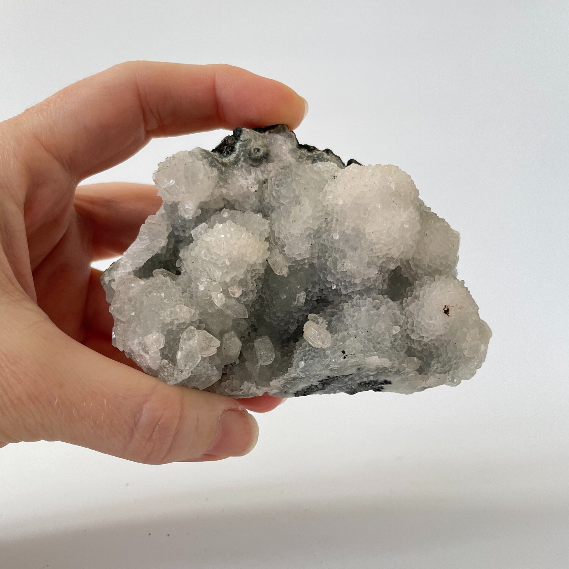 A 4-inch rare blue chalcedony cluster with soft blue hues on a white background.