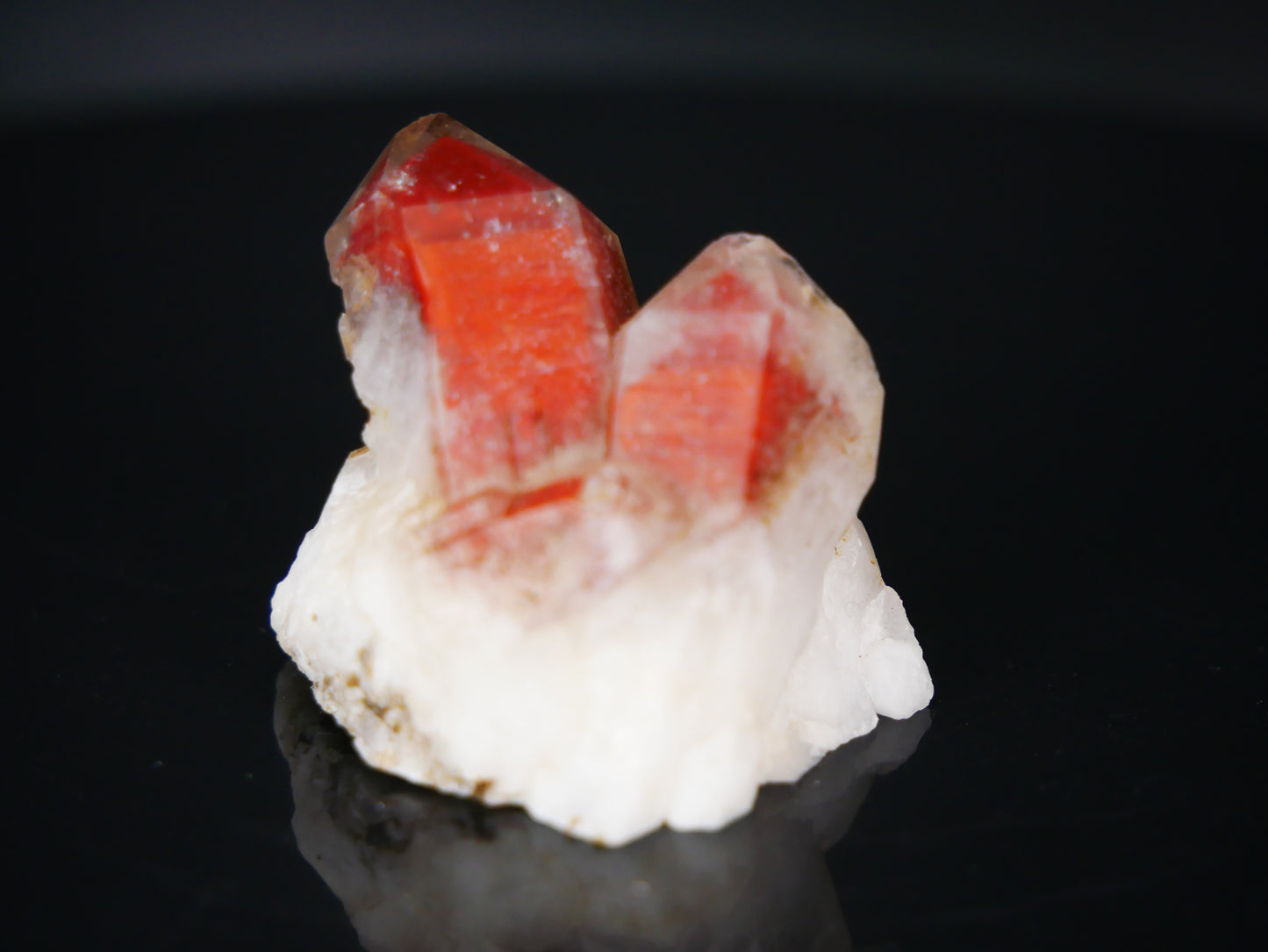 A stunning 20-gram Red Phantom Quartz specimen, showcasing vibrant hues of red within its crystal structure, against a backdrop of earthy tones