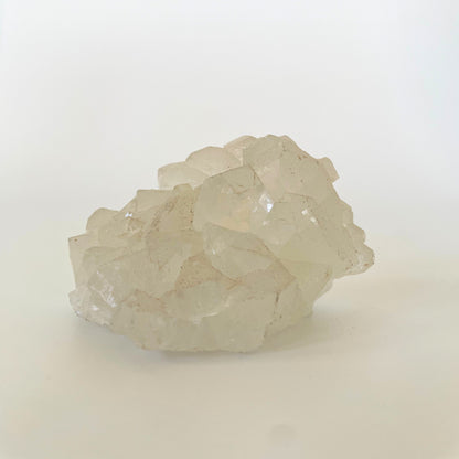 A 3-inch clear apophyllite cluster with distinctive crystal formations on a white background.