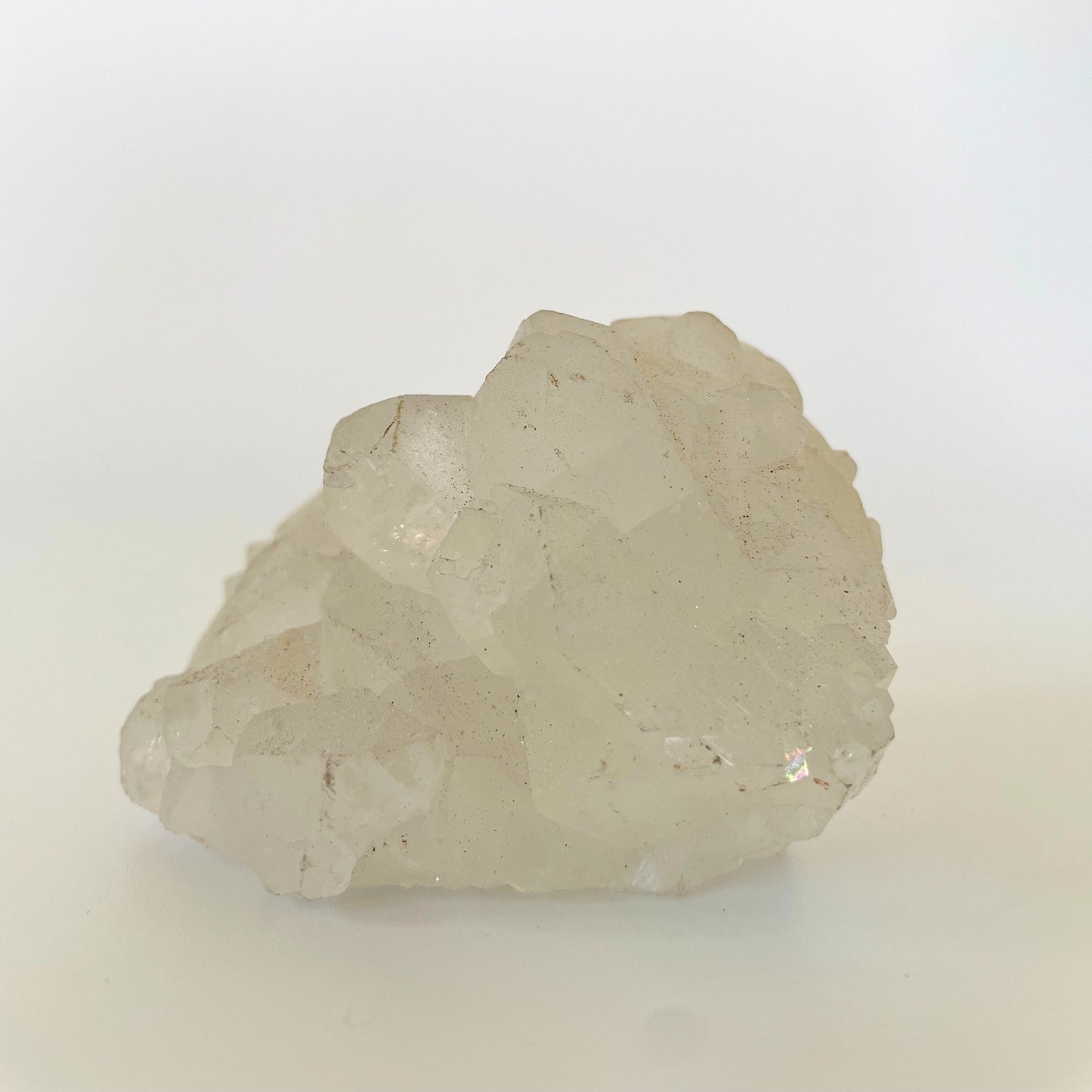 A 3-inch clear apophyllite cluster with distinctive crystal formations on a white background.