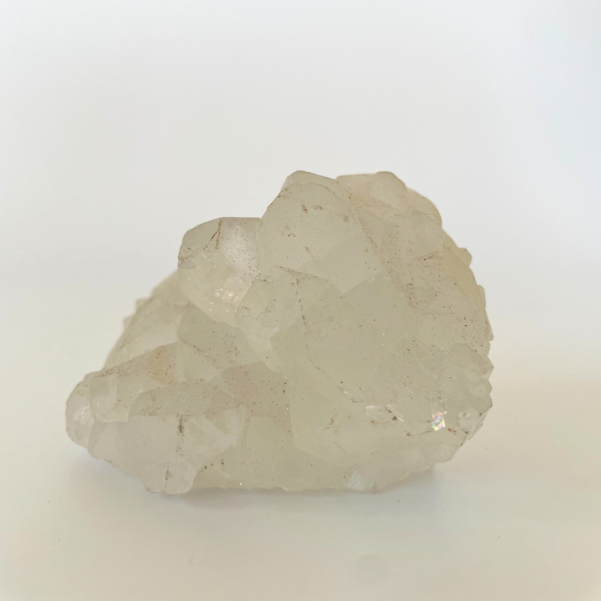 A 3-inch clear apophyllite cluster with distinctive crystal formations on a white background.