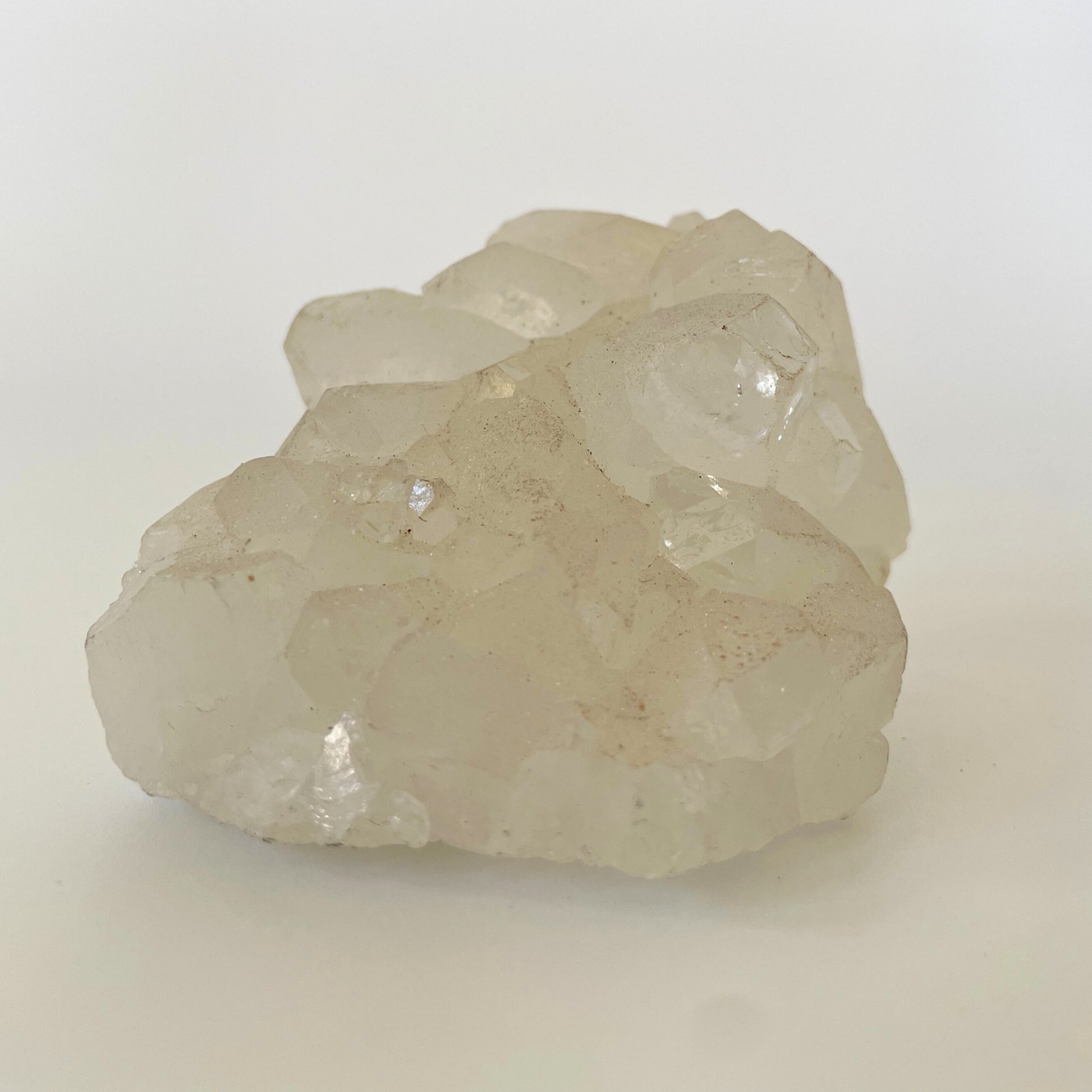 A 3-inch clear apophyllite cluster with distinctive crystal formations on a white background.