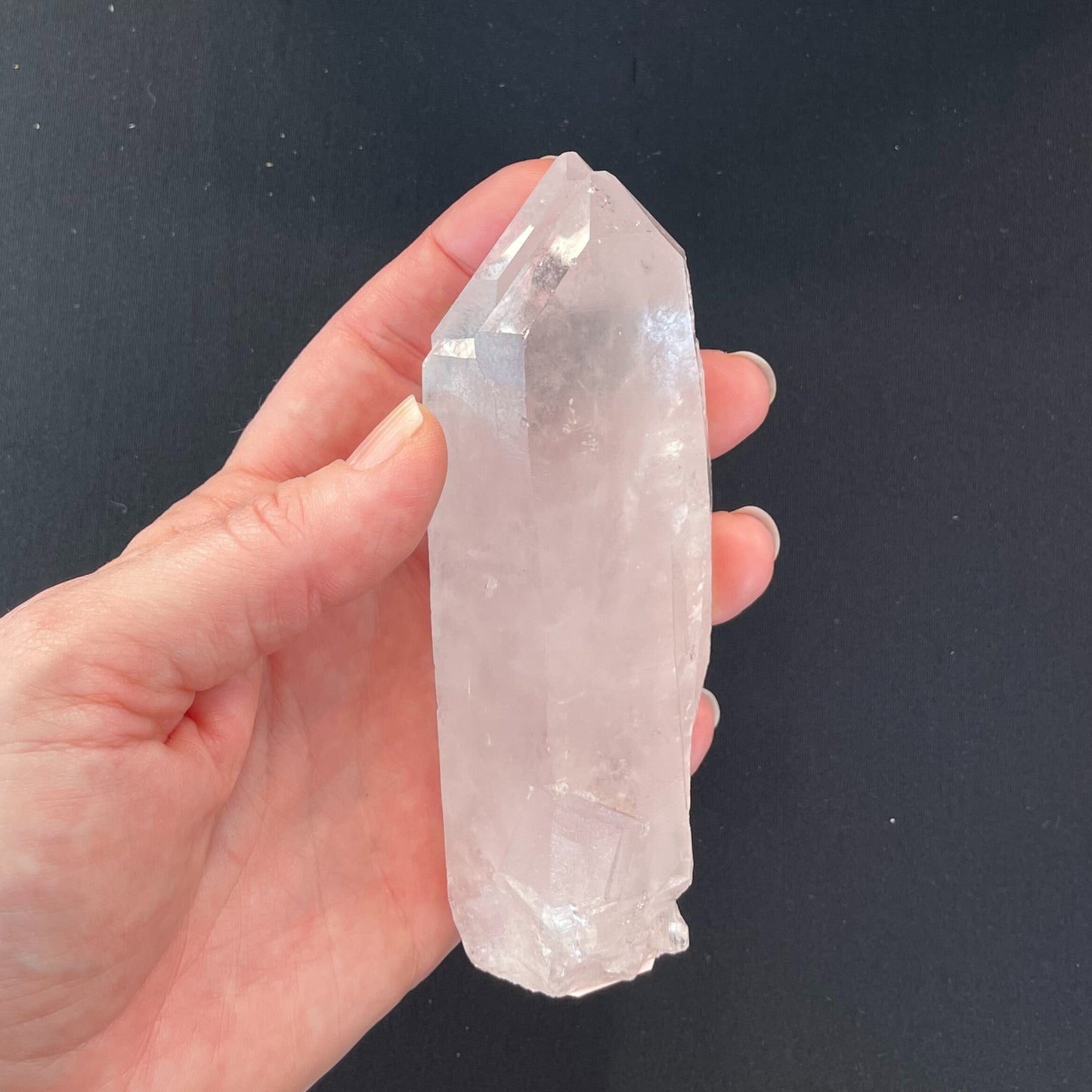 Close-up of a double-point clear quartz crystal, measuring nearly two inches in length, showcasing its transparent beauty and intricate crystalline structure.