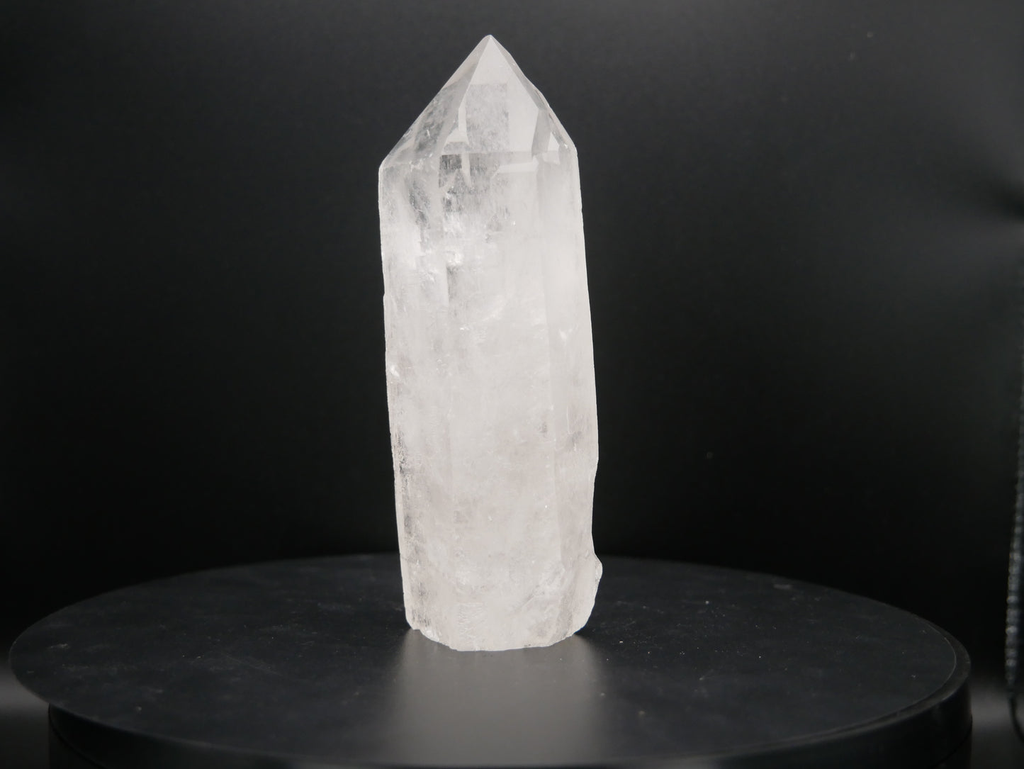 A clear quartz tower with double points, measuring 1.76 inches in height and weighing 291.2 grams. The quartz is transparent, allowing light to pass through, and features natural facets and striations, reflecting its crystalline structure.