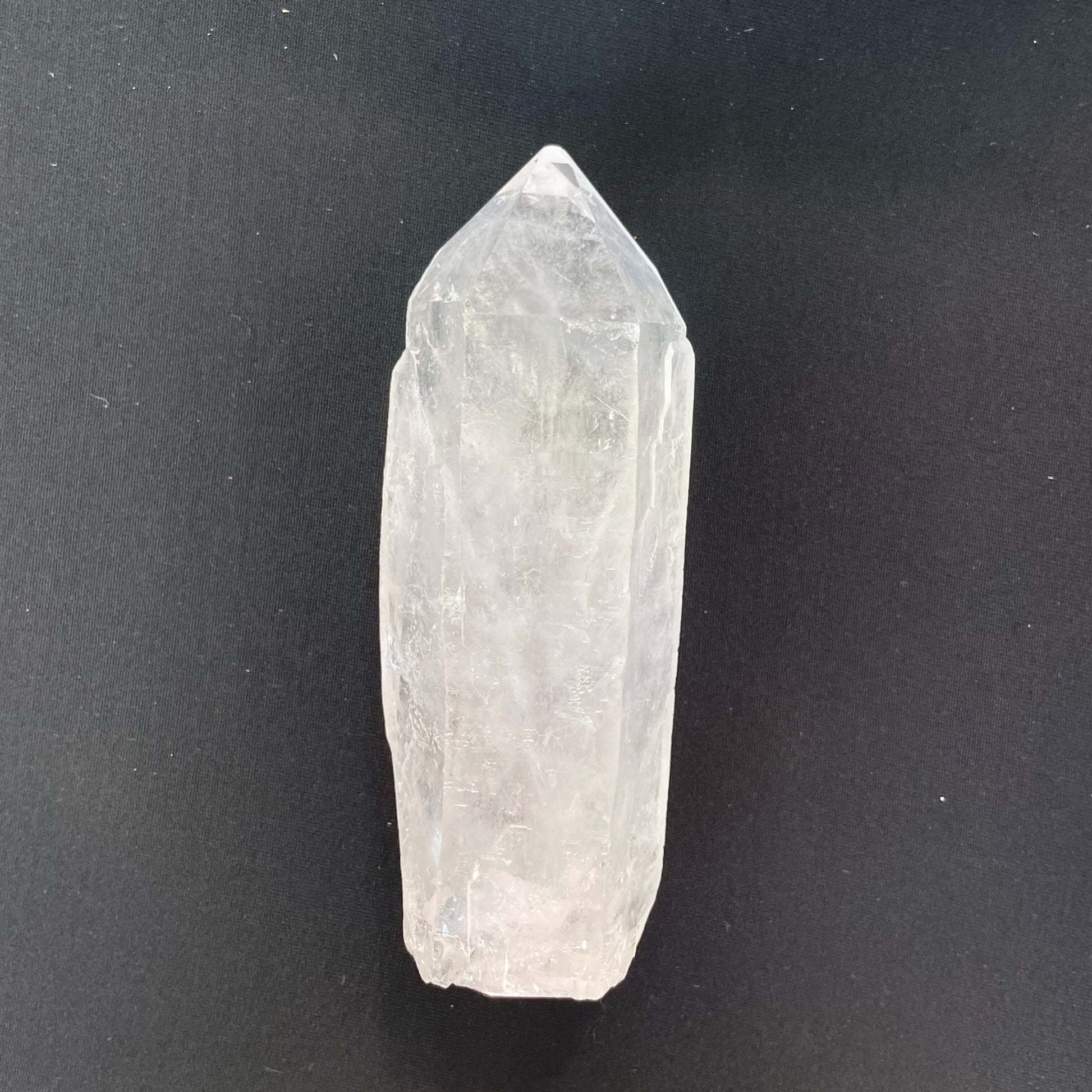 Close-up of a double-point clear quartz crystal, measuring nearly two inches in length, showcasing its transparent beauty and intricate crystalline structure.