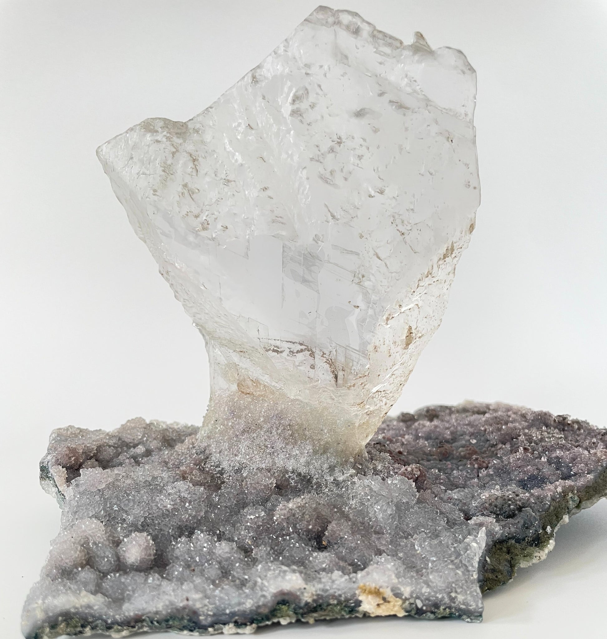 Large slab of amethyst with micro-crystallization with a large formation of gypsum protruding perpendicular from the slab.