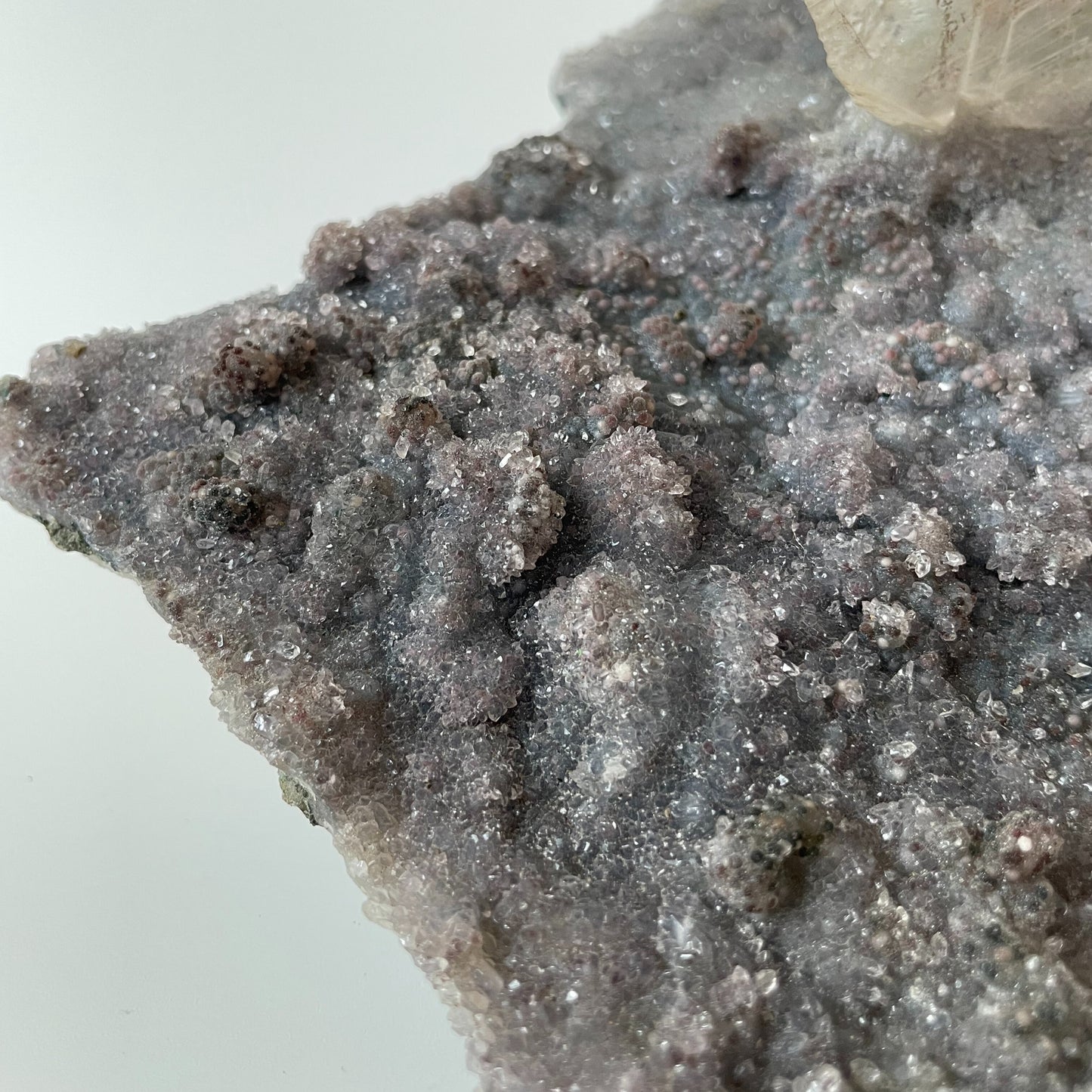 Large slab of amethyst with micro-crystallization with a large formation of gypsum protruding perpendicular from the slab.