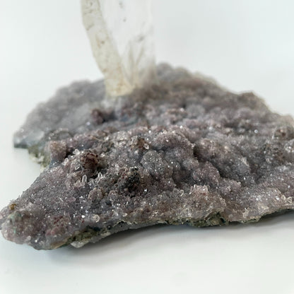 Large slab of amethyst with micro-crystallization with a large formation of gypsum protruding perpendicular from the slab.