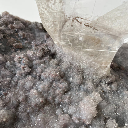 Large slab of amethyst with micro-crystallization with a large formation of gypsum protruding perpendicular from the slab.