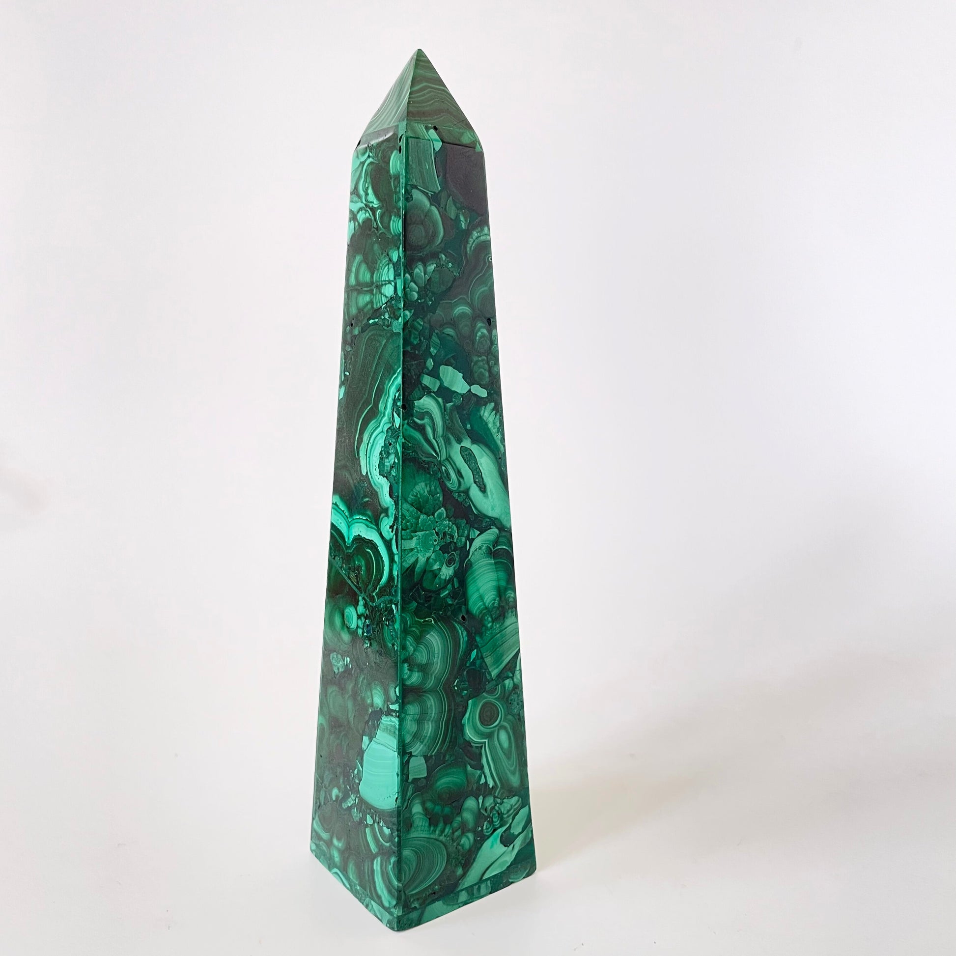 A 5.92-inch malachite obelisk with vibrant green hues and intricate patterns on a white background.