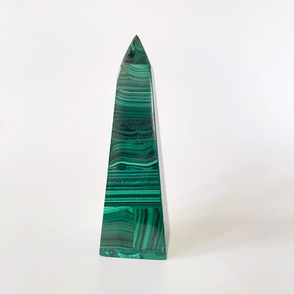 A 3.9-inch malachite obelisk with vibrant green hues and intricate patterns on a white background.