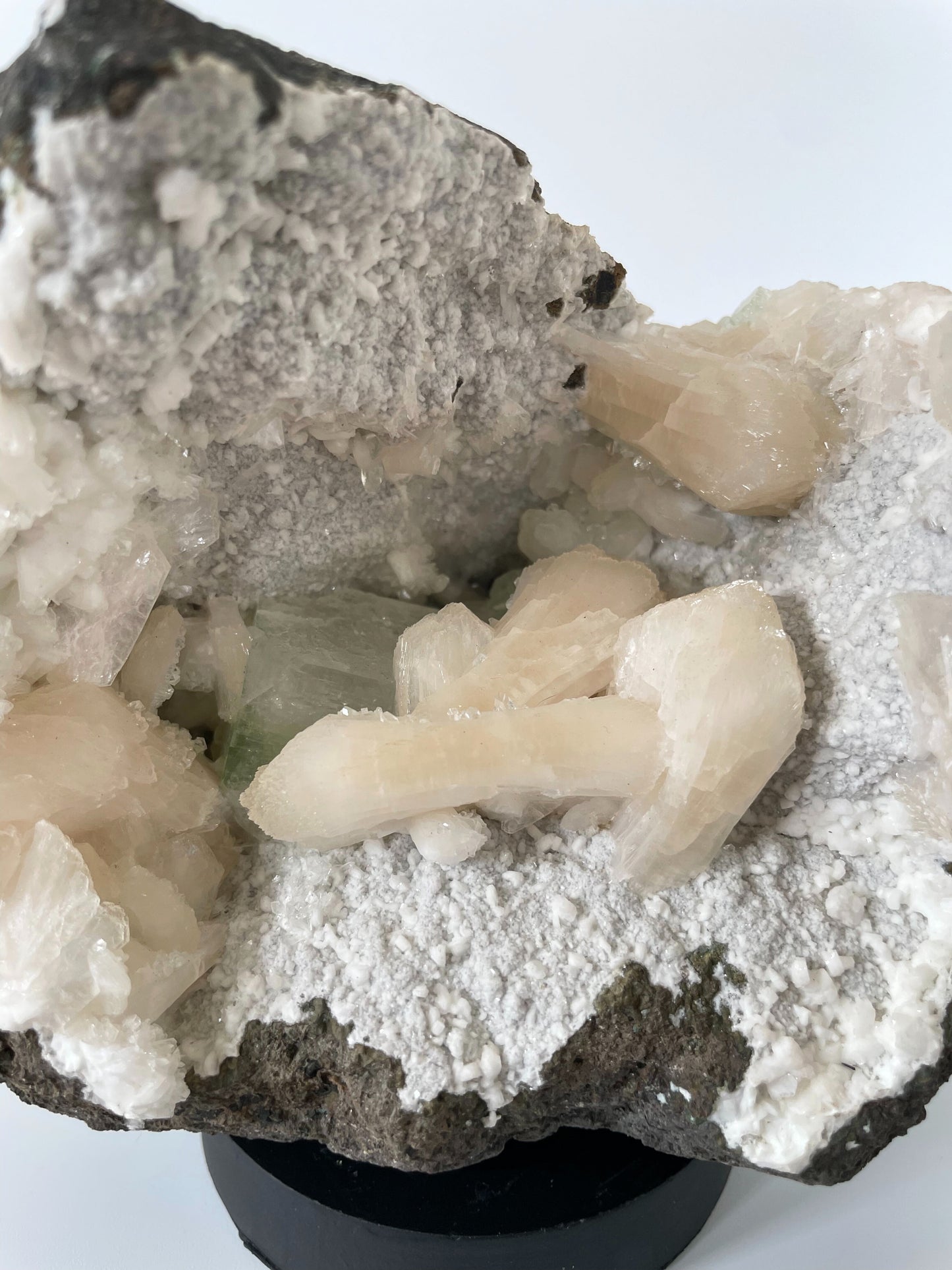 A close-up of a large Heulandite cluster with well-defined peach Stilbite and green Apophyllite crystals.