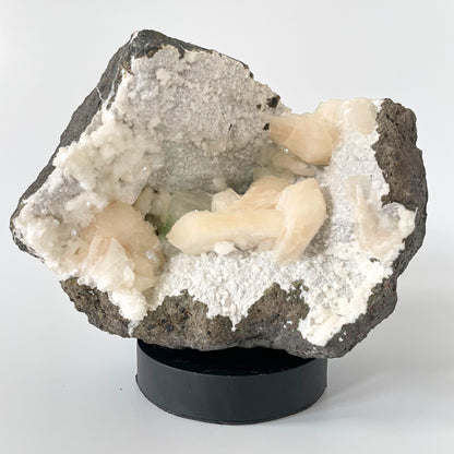 A close-up of a large Heulandite cluster with well-defined peach Stilbite and green Apophyllite crystals.